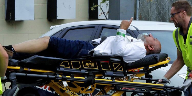 Ambulance staff take a man from outside a mosque in central Christchurch, New Zealand on Friday. Four people are in custody after shootings at two mosques there.