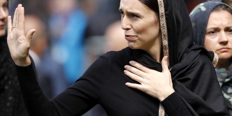 New Zealand Prime Minister Jacinda Ardern, center, waves as she leaves Friday prayers at Hagley Park in Christchurch, New Zealand, Friday, March 22, 2019. People across New Zealand are observing the Muslim call to prayer as the nation reflects on the moment one week ago when 50 people were slaughtered at two mosques. (AP Photo/Vincent Thian)