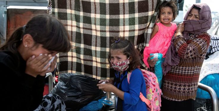 Refugees and migrants from the destroyed camp of Moria react to tear gas fired by riot police during clashes, on the island of Lesbos, Greece, September 12, 2020. REUTERS/Alkis Konstantinidis