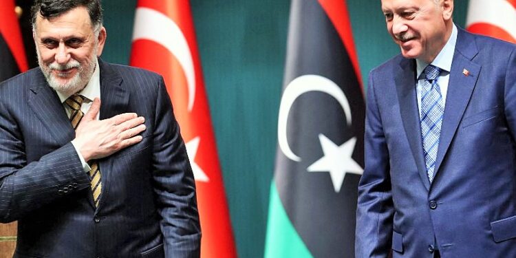 (FILES) In this file photo taken on June 4, 2020, Turkish President Recep Tayyip Erdogan (R) and Libyan Prime Minister Fayez al-Sarraj (L) hold a joint press conference at the Presidential Complex in Ankara. - Ten years after Libya's NATO-backed uprising ousted and killed dictator Moamer Kadhafi, the country remains wracked by conflict and chaos, its population bled dry despite the nation's vast oil wealth. A UN-led process has lifted cautious hopes that the latest fragile ceasefire will bring a lasting peace, but, for now, Libya is split in two by rival camps with their own militias, mercenaries and foreign backers. (Photo by Adem ALTAN / AFP)