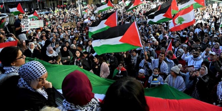 Protesters wave Palestinian flags during a demonstration against Israel at the Town Hall in Sydney on May 15, 2021, amid the ongoing conflict between Israel and the Palestinian Territories. (Photo by BIANCA DE MARCHI / AFP)