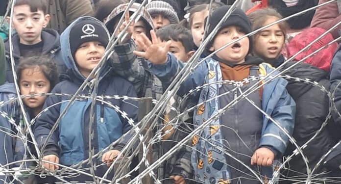 Migrants children gather near the fence on the Poland/Belarus border near Kuznica, Poland, in this video-grab released by the Polish Interior Ministry, November 11, 2021. MON/Handout via REUTERS THIS IMAGE HAS BEEN SUPPLIED BY A THIRD PARTY