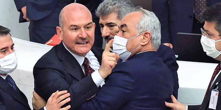 Turkey Interior Minister Suleyman Soylu (2L) gestures towards the opposition Republican People's Party deputies while discussing the 2022 budget of the Ministry of Interior at Turkish Grand National Assembly in Ankara on December 8, 2021. (Photo by Adem ALTAN / AFP)