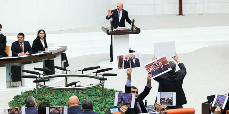 Turkish Opposition deputies protest by holding placards as Interior Minister Suleyman Soylu (Top) speaks on the ministry's 2023 budget at the Turkish Grand National Assembly (TBMM) in Ankara on December 10, 2022. (Photo by Adem ALTAN / AFP)