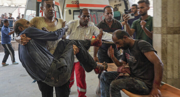 EDITORS NOTE: Graphic content / People injured during Israeli bombardment arrive at Nasser hospital in Khan Yunis, on the southern Gaza Strip on July 9, 2024, amid the ongoing conflict between Israel and the Palestinian militant group Hamas. - A deadly strike hit a school turned shelter in southern Gaza on July 9 as Israeli forces in the war-ravaged territory's main city pushed on with a major offensive that has again displaced Palestinians. A hospital source in Khan Yunis said at least 29 people were killed when the Al-Awda school was hit in nearby Abasan while the Israeli military said its air force had carried out a strike in the area targeting a "terrorist" and would review the incident. (Photo by Bashar TALEB / AFP)