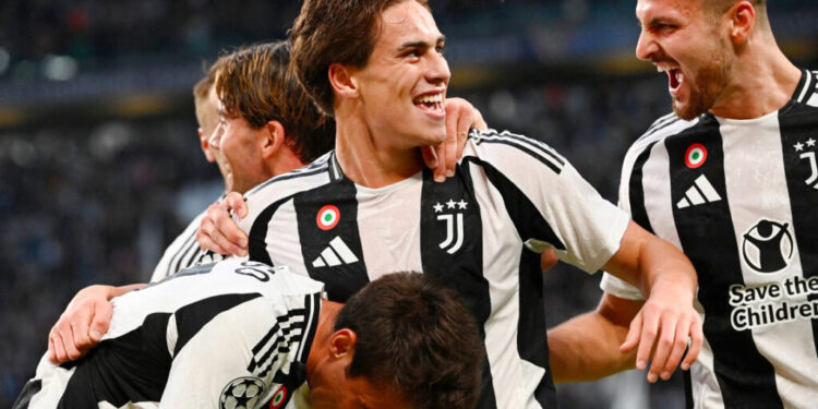 Juventus' Turkish forward #10 Kenan Yildiz (C) celebrates scoring his team's first goal during the UEFA Champions League 1st round day 1 football match between Juventus FC and PSV Eindhoven, at the Juventus Stadium in Turin on September 17, 2024. (Photo by Isabella BONOTTO / AFP)