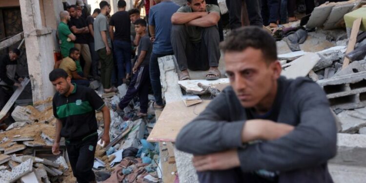 People check the destruction following an Israeli strike that hit the home of a Palestinian family in Jabalia in the northern Gaza Strip on May 23, 2025. Gaza's civil defence agency said Israeli strikes killed 16 people on May 23 across the territory, where Israel has ramped up its military offensive in recent days. (Photo by Bashar TALEB / AFP)