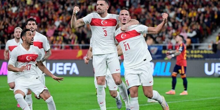 Turkey's forward #21 Deniz Gul (R) celebrates with Turkey's defender #03 Merih Demiral scoring his team's first goal during the FIFA World Cup 2026 European qualification Group E football match between Spain and Turkey at the Cartuja stadium in Seville on November 18, 2025.  (Photo by CRISTINA QUICLER / AFP)