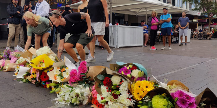People offer flowers for the victims of Saturday's stabbings at Bondi Junction in Sydney, Australia, April 14, 2024. REUTERS/Alasdair Pal