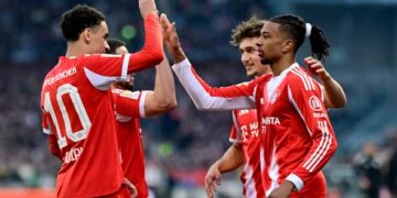 Soccer Football - Bundesliga - St. Pauli v Bayern Munich - Millerntor-Stadion, Hamburg, Germany - April 11, 2026 Bayern Munich's Michael Olise celebrates scoring their third goal with teammates REUTERS/Fabian Bimmer DFL REGULATIONS PROHIBIT ANY USE OF PHOTOGRAPHS AS IMAGE SEQUENCES AND/OR QUASI-VIDEO.
