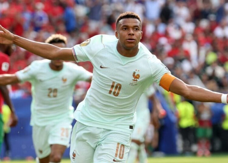 France's forward #10 Kylian Mbappe celebrates scoring his team's first goal during the 2026 World Cup football tournament quarter-final match between France and Morocco at Boston Stadium in Foxborough on July 9, 2026.  (Photo by Odd ANDERSEN / AFP)