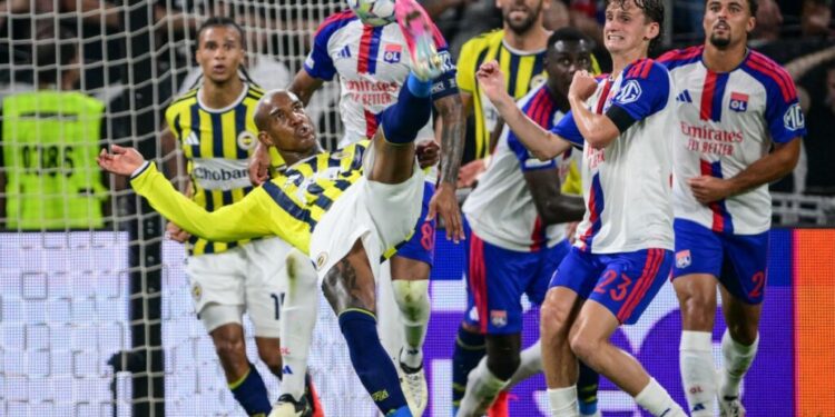 Fenerbahce's Brazilian #94 Anderson Talisca (2L) performs an overhead kick as he shoots towards goal during the UEFA Champions League qualifying playoff - second leg football match between Olympique Lyonnais (OL) and Fenerbahce SK at the Groupama Stadium in Decines-Charpieu, central-eastern France, on August 26, 2026. (Photo by OLIVIER CHASSIGNOLE / AFP)