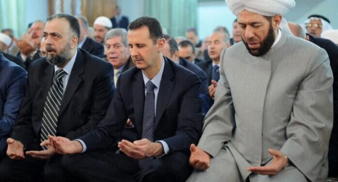 A handout picture released by the Syrian Arab News Agency (SANA) on August 8, 2013 shows Syrian President Bashar al-Assad (C) and Syrian Grand Mufti Ahmed Hassun (R) attending the Eid al-Fitr morning prayer in Damascus. AFP PHOTO/HO/SANA
=====RESTRICTED TO EDITORIAL USE - MANDATORY CREDIT "AFP PHOTO / HO / SANA" - NO MARKETING NO ADVERTISING CAMPAIGNS - DISTRIBUTED AS A SERVICE TO CLIENTS ====== (Photo by SANA / AFP)